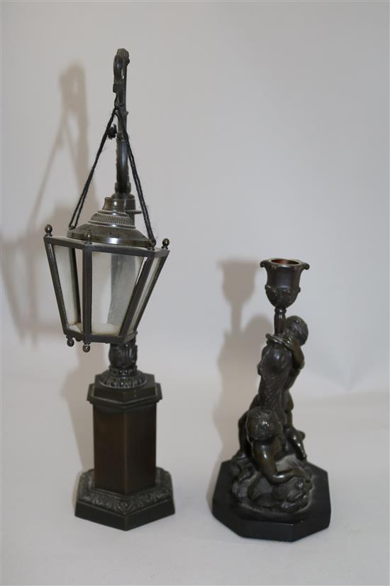 A bronze candlestick & a miniature lantern